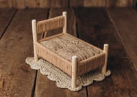 Image 3 of A wooden bed wrapped with thick rope