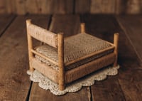 Image 2 of A wooden bed wrapped with thick rope