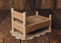 Image 4 of A wooden bed wrapped with thick rope
