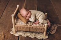 Image 8 of A wooden bed wrapped with thick rope