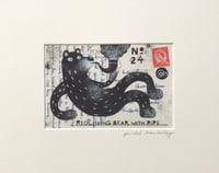 Image 1 of Reclining Bear with Pipe