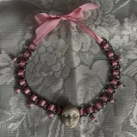 cursed face necklace