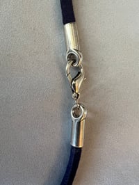 Image 4 of Silver ring on blue cording