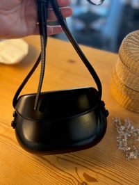 Image 2 of Leather handbag with a rounded shape Black 