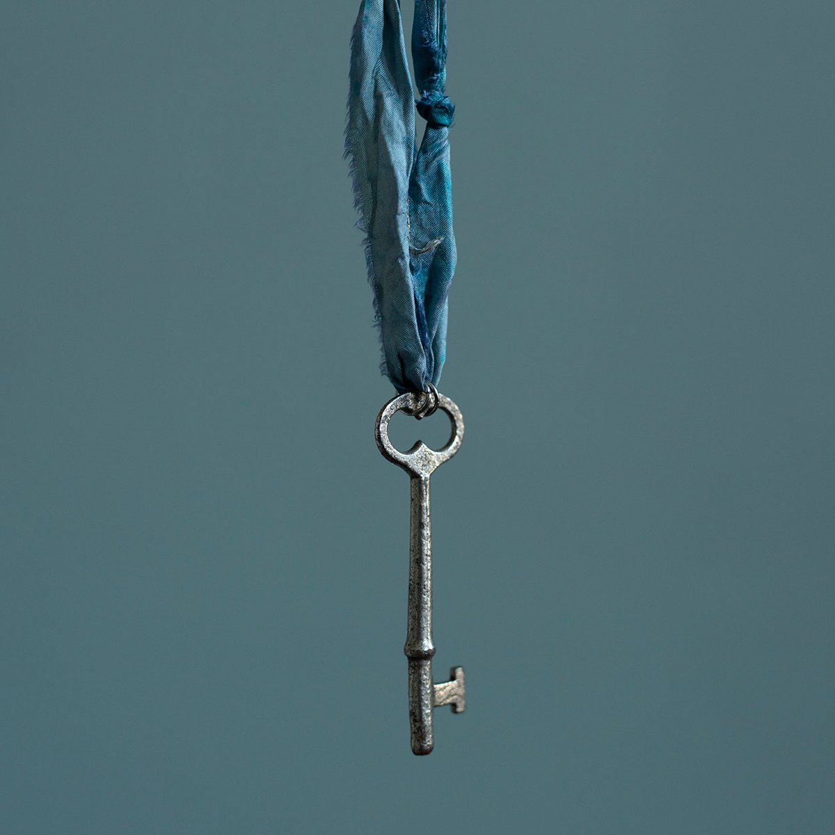Large silver key on "dusty cloud" cord