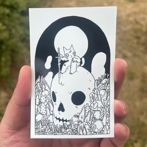 Image of Cat Sitting on Skull Sticker
