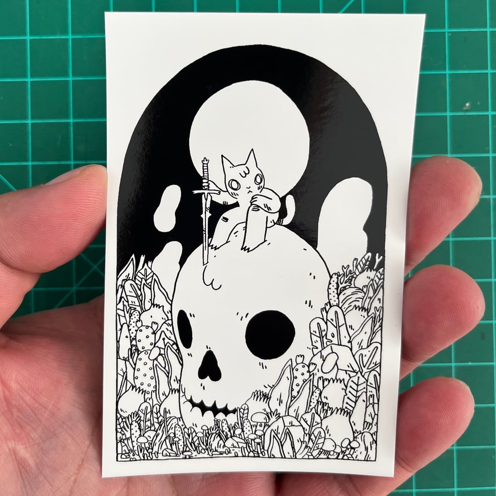 Image of Cat Sitting on Skull Sticker