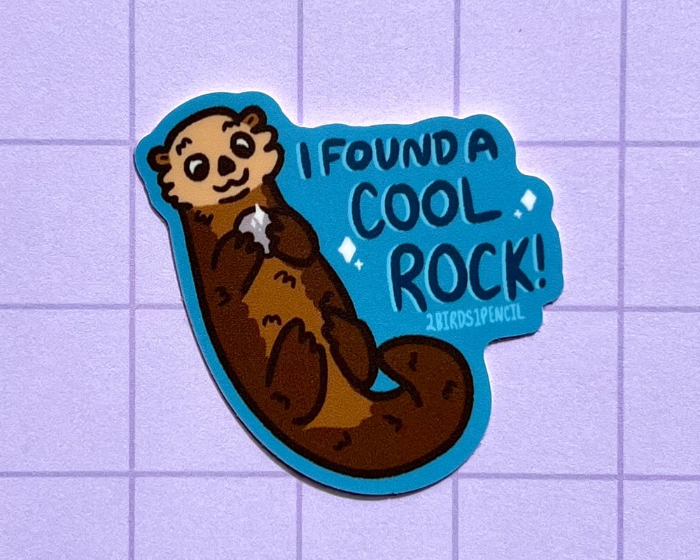 Image of Otter with a rock mini vinyl sticker
