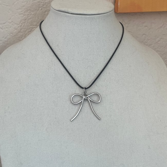 big silver bow black cord necklace