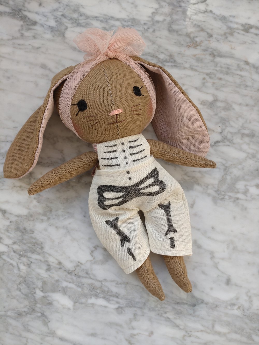 Image of Little bunny in skeleton outfit