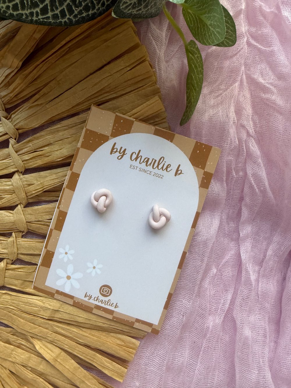 Image of baby pink knot studs 