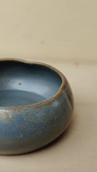 Image 1 of **Flower-Shaped Bowl - Deep Blue Speckled - rich, oceanic tones