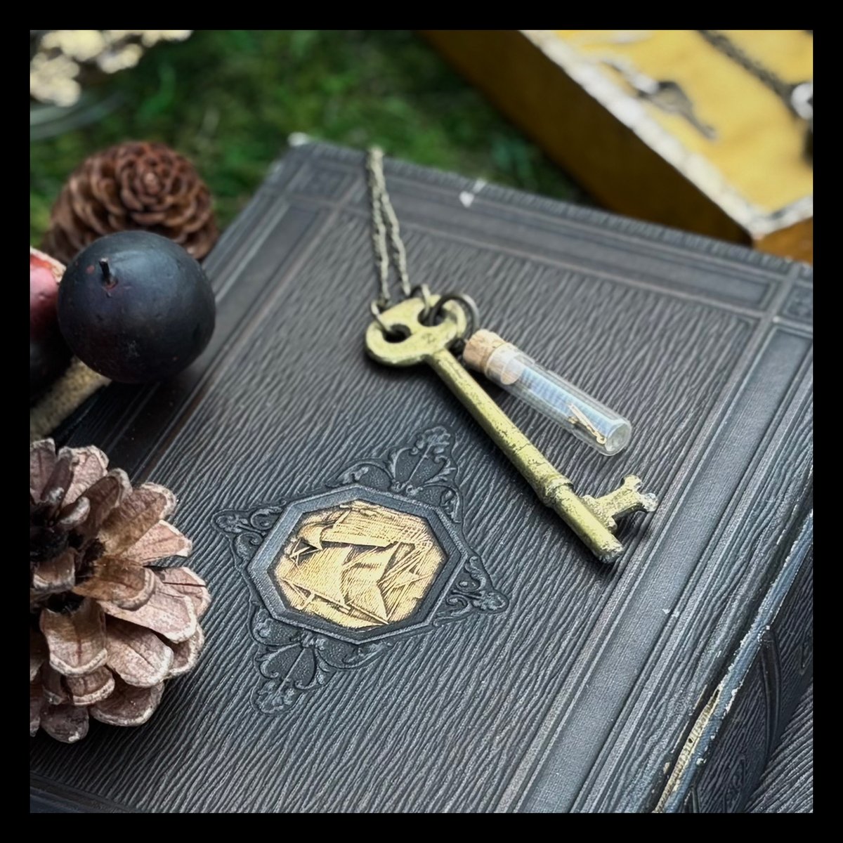 Large brass key with vintage clock parts in vial