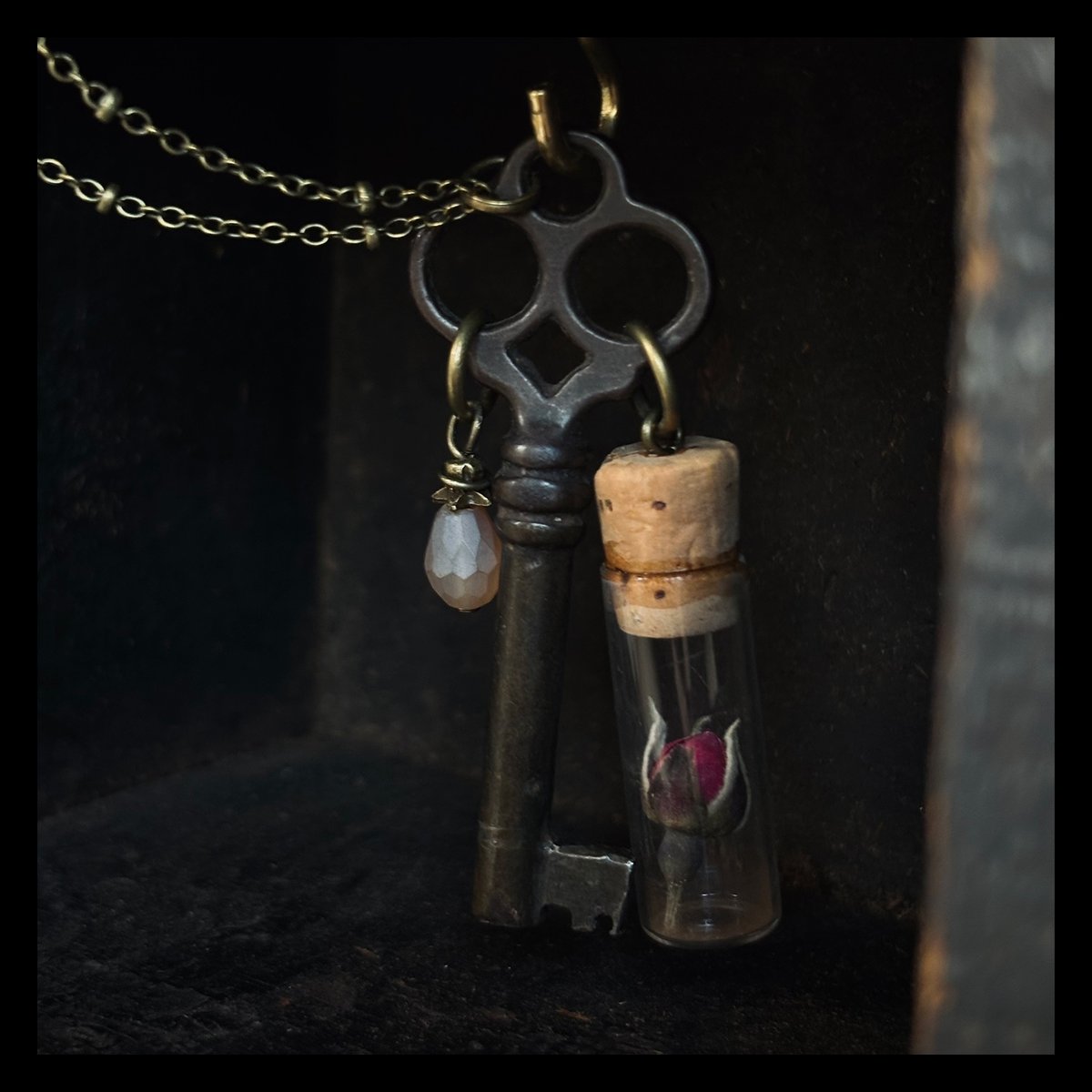 Skeleton key with bead & vintage clock parts vial with dried rosebud