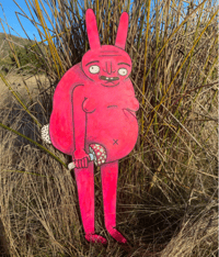 Pink rabbit holding a mushroom - stage décor art piece.