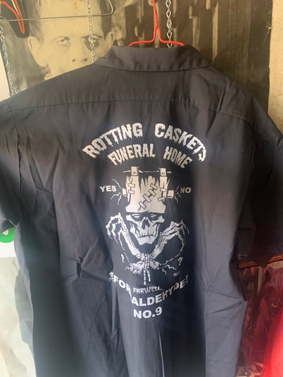 Image of Xlg ROTTING CASKETS FUNERAL HOME  Preworn Workshirts with Patches on the front look at second pictur