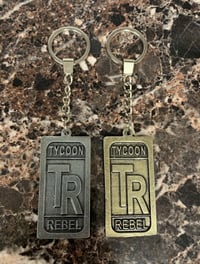 Image 1 of SET OF 2 TYCOONREBEL CLOTHING CO.  METAL LUXURY KEYCHAINS SILVER & GOLD COLOR.
