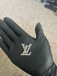 1 x silver metal L.v. charm.