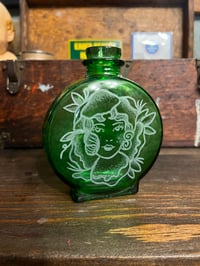 Girl on an antique green bottle 