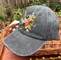 Image 3 of Dark, medium and light pink hand embroidered flowers on an adjustable dark green fabric hat