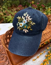 Image 2 of Blue and turquois hand embroidered flowers on an adjustable dark blue jean fabric hat