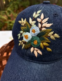Image 4 of Blue and turquois hand embroidered flowers on an adjustable dark blue jean fabric hat