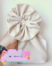 Image 1 of Mystery pleather bows