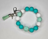 Turquoise beaded wristlet keychain with silver toned cross 