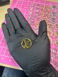 1 x Gold metal L.v. charm. (4 LEFT TO PURCHASE)