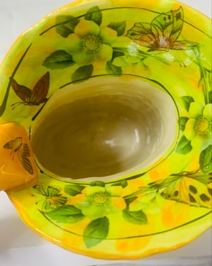 Image of Small orange and yellow jug