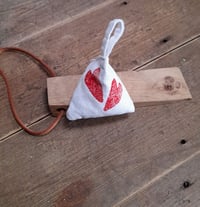 Image 1 of Lavender Bag in the shape of a pyramid.