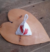 Image 2 of Lavender Bag in the shape of a pyramid.