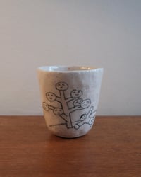 Image 1 of ‘A man rests under the tree.’ Cup 