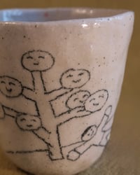 Image 2 of ‘A man rests under the tree.’ Cup 