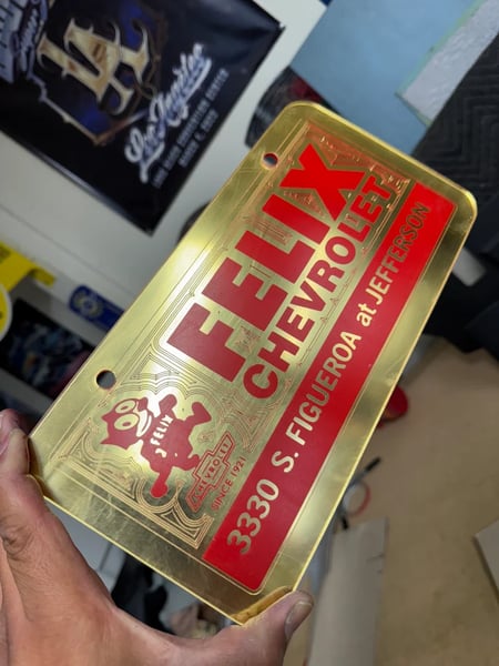Image of GOLD & RED FELIX CHEVROLET ICONIC LICENSE PLATE