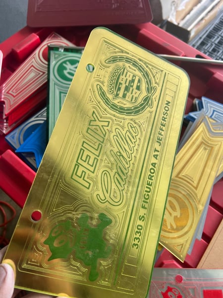 Image of GOLD & GREEN FELIX CADILLAC ICONIC LICENSE PLATE