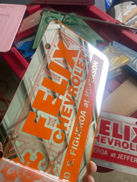 Image of CHROME & ORANGE FELIX CHEVROLET LICENSE PLATE