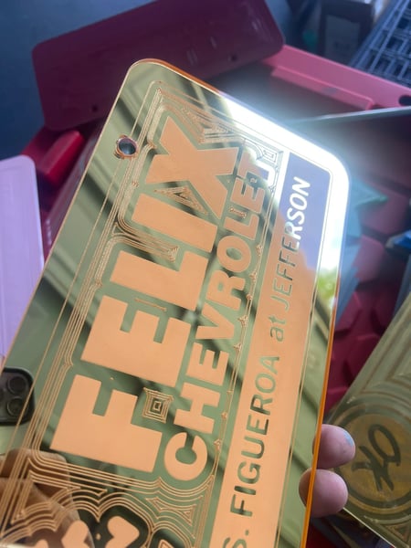 Image of GOLD & PINK FELIX CHEVROLET ICONIC LICENSE PLATE