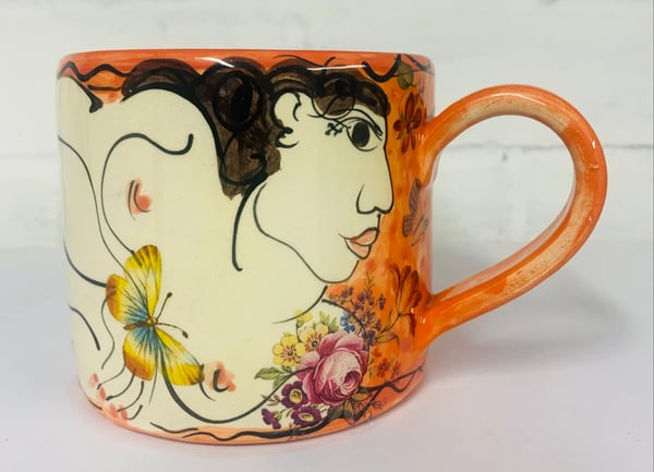 Image of Bright orange cylinder figurative mug