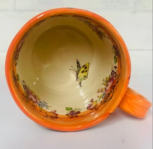 Image of Bright orange cylinder figurative mug