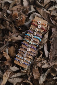 Image 1 of BRACCIALI -con fetta di corno e perline- 