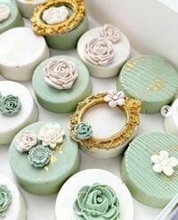 Image 3 of Sage green, white, and gold treat package with 2 dozen royal icing cookies