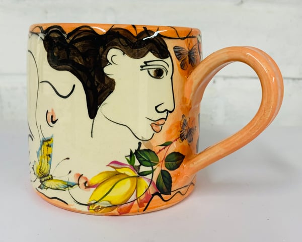 Image of Peach coloured figurative cylinder mug