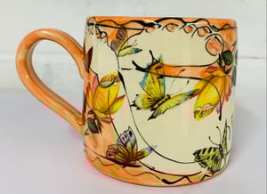 Image of Peach coloured figurative cylinder mug