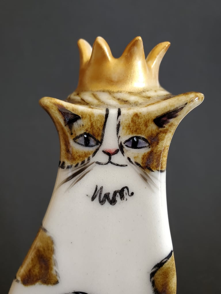 Brown and white moggy bud vase