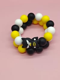 Image 1 of Black and yellow silicone beaded superhero charm bracelet for women teens and girls
