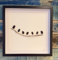 Seaglass birds on driftwood branch