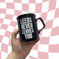 Image 1 of Leeds Never Leaves You Black Mug