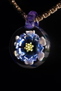 Image 1 of blue daisy flower pendant made by Roe glass. 