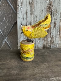 Image 3 of Small yellow bird on spool